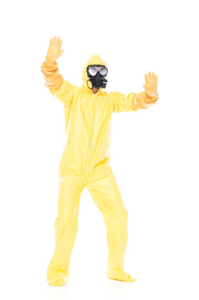 istock Man in protective clothing holding hands out in a stop gesture 1173978454
