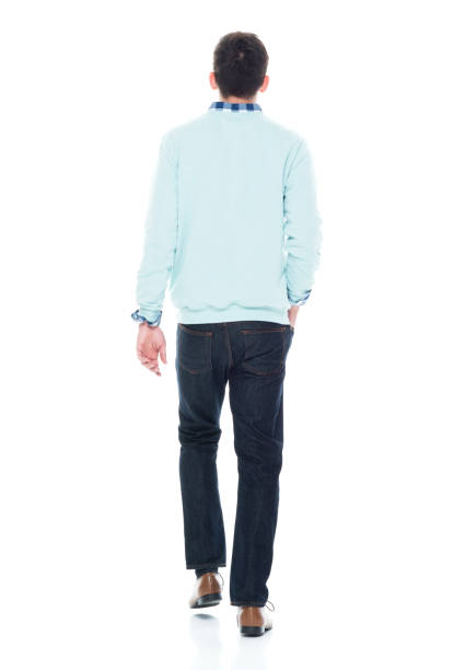 istock Handsome young man walking rear view 1173979240