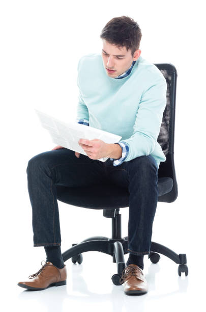 Back view of a man sitting on a chair. Rear view people collection.  backside view of person.  Isolated over white background. The guy comfortably sprawled on a chair.