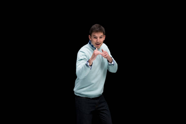 istock Good looking man wearing blue sweater and in fighting stance 1173979526