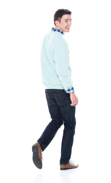 istock Handsome young man walking and looking behind, rear view. 1173979796