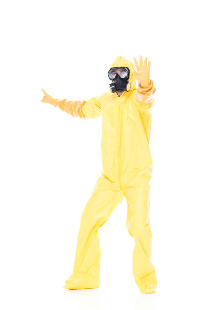 istock Man in protective clothing holding hands out in a stop gesture 1173980166