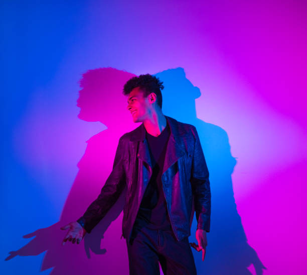 istock Handsome man with purple and blue lighting 1173981418