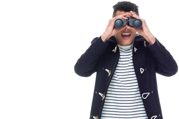 istock Handsome black man with curly hair and wearing a jacket - binoculars 1173981886