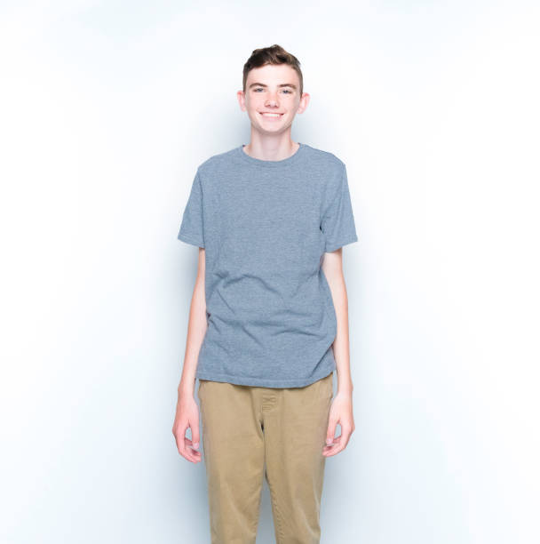 istock Young 13 year old boy standing in front of white wall 1173985736