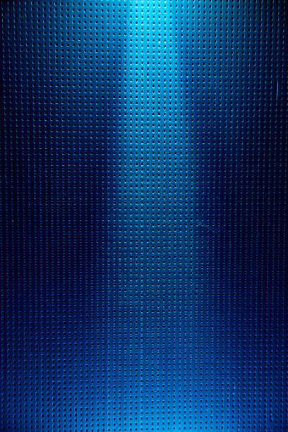 istock Dark blue background with a black dot on top lit by a light blue ray of light 1173992594