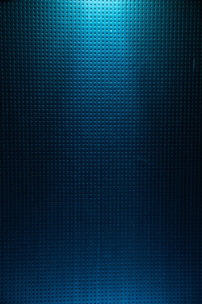 istock A light blue diffused light beam from above illuminates the blue background to a point 1173994048