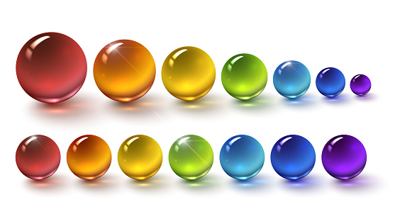 Set of multi-colored glass balls on a white background, round drops of rainbow colors