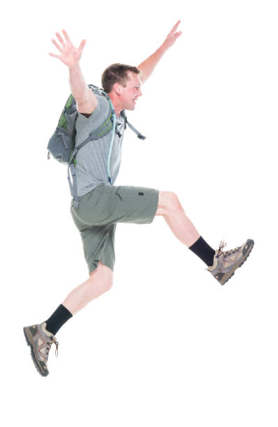istock Friendly male hiker is jumping with excitement, side view 1174008964