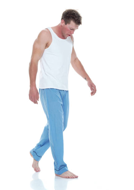 istock Tired man wearing pajamas and walking 1174009174