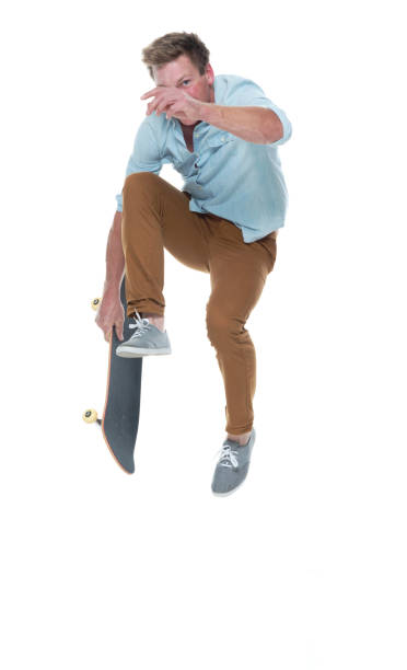 istock Casual well dressed man jumping with a skateboard 1174009407