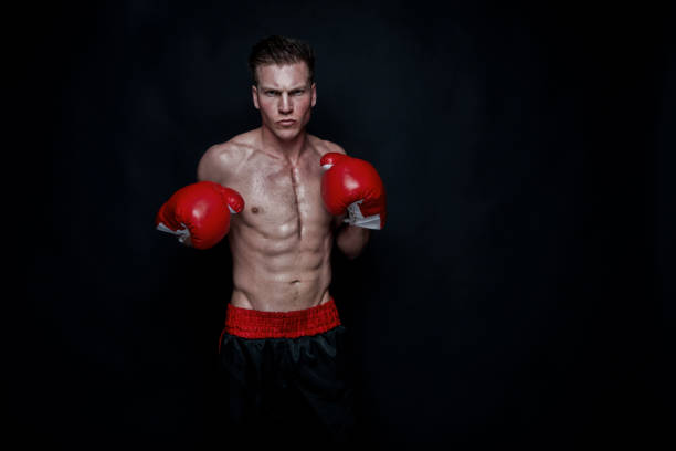 istock Sexy male boxer on black background 1174011100