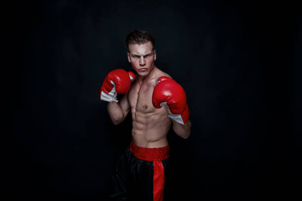 istock Sexy male boxer on black background 1174011322