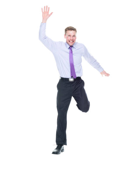 istock Attractive young caucasian man in business attire - front view jumping 1174012978