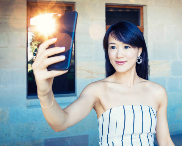 istock Beautiful Asian woman using smart phone,Turkey. 1174013276