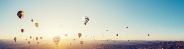 aerial view of hot air balloons over cappadocia at sunrise，turkey.(panorama xxl) - cappadocia hot air balloon turkey basket imagens e fotografias de stock