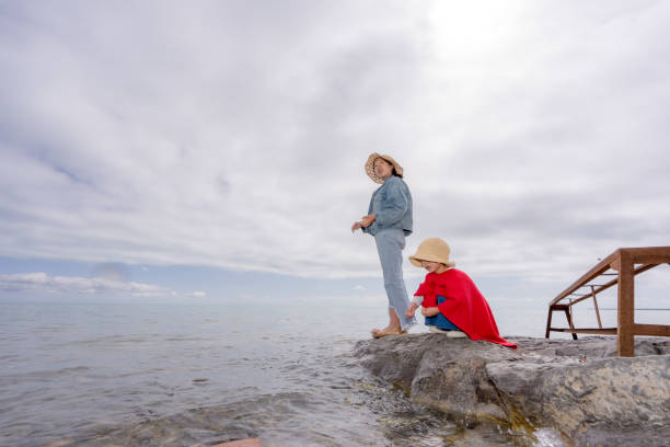 two sisters by the lake side feeding fishes