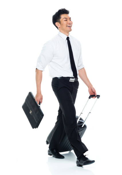 istock Asian businessman holding briefcase and suitcase and walking 1174016663