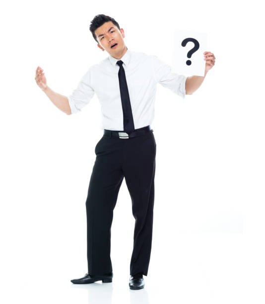 istock Handsome Asian Businessman - is holding a question mark sign 1174016706
