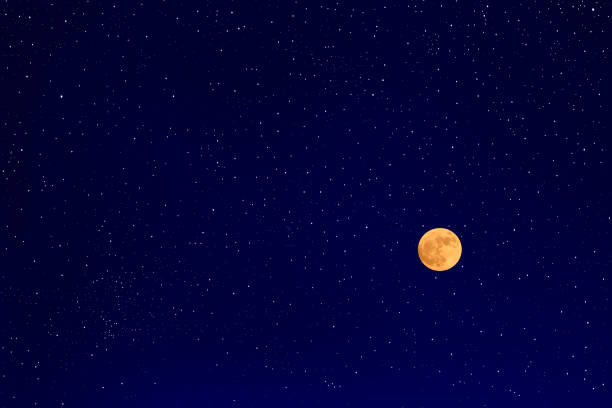 Full moon with lots of shiny stars in the midnight sky.