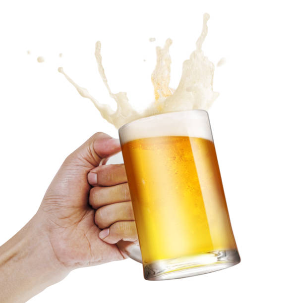 istock Hand holding a mug of light beer toasting with bubble froth splash isolate white background with copy space 1174029192