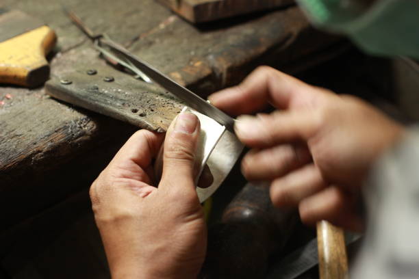 istock hands and tools of a professional silversmith working on a piece in his traditional workshop, Northern Thailand 1174035287