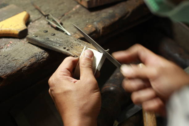 istock hands and tools of a professional silversmith working on a piece in his traditional workshop, Northern Thailand 1174035315