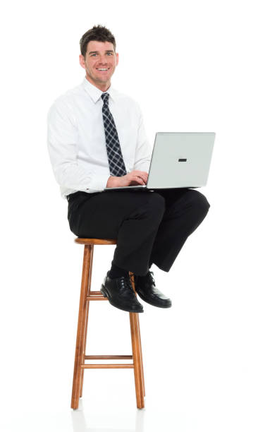 Full length / one man only / side view / profile view of 30-39 years old handsome people caucasian male / mid adult men / mid adult businessman / business person / manager sitting / resting in front of white background who is working Full length / one man only / side view / profile view of 30-39 years old handsome people caucasian male / mid adult men / mid adult businessman / business person / manager sitting / resting in front of white background wearing button down shirt / shirt / necktie / pants who is smiling / happy / cheerful who is working and using laptop / computer / sitting on stool 2655 stock pictures, royalty-free photos & images