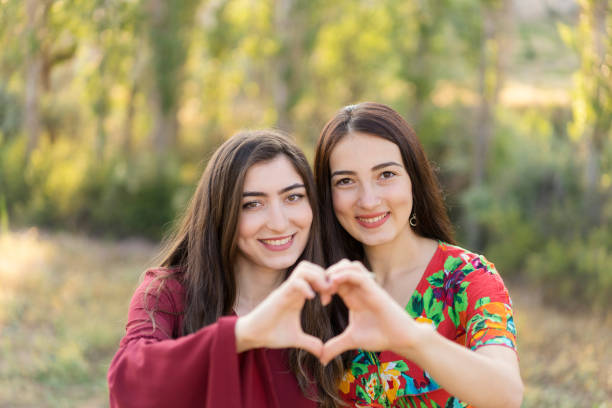 istock Girlfriends cheering outdoors 1174044490