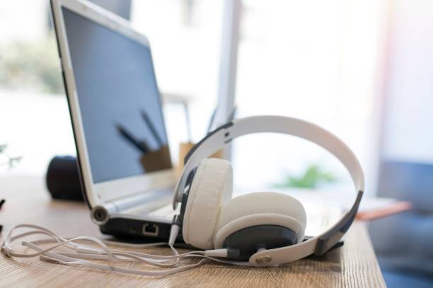 istock headphones with laptop on the desktop 1174046805