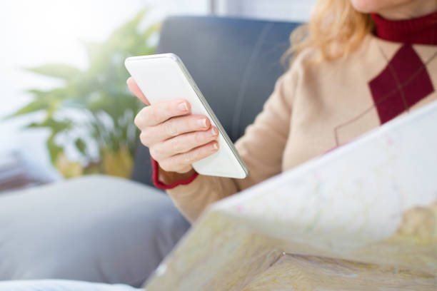 istock hand with mobile phone pointing to the map, travel and vacation 1174046832