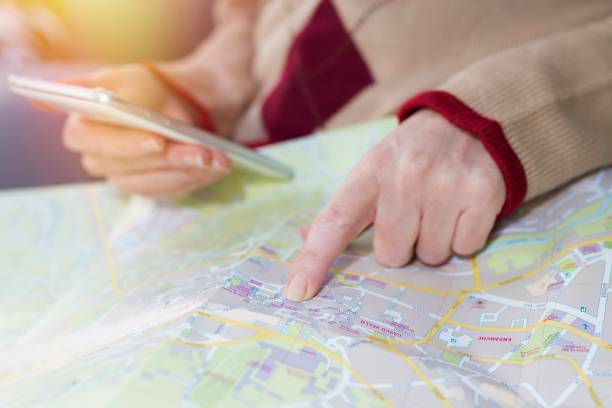 istock hand with mobile phone pointing to the map, travel and vacation 1174046873