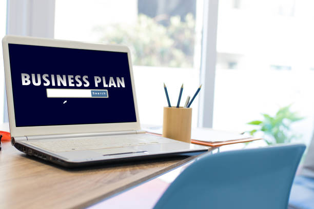 istock desktop with laptop and business plan concept 1174046946