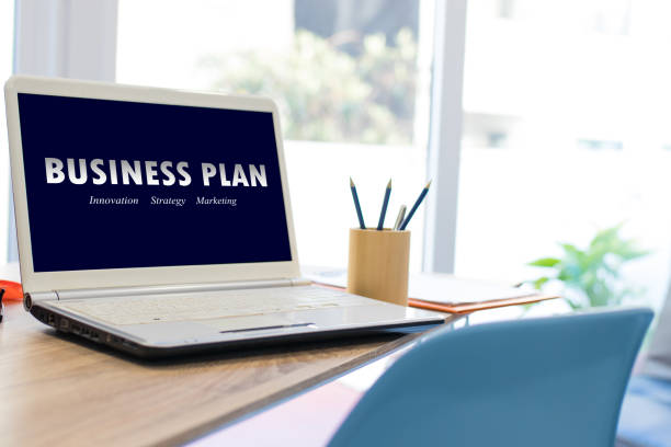 istock desktop with laptop and business plan concept 1174046980