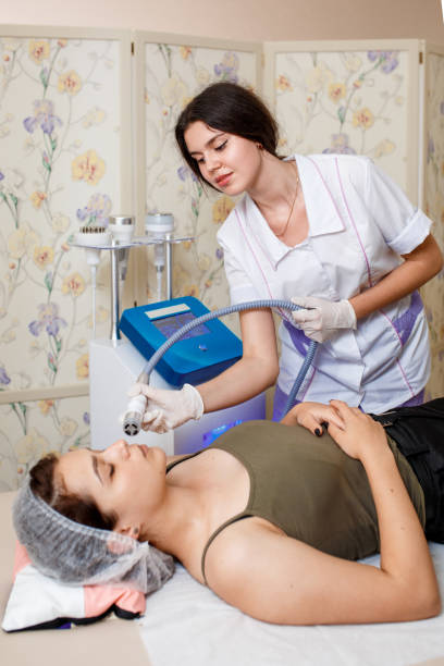 istock Lymphatic drainage massage LPG apparatus process. Therapist beautician makes a rejuvenating facial massage for the woman in a SPA salon. Beauty and bodycare concept 1174047278