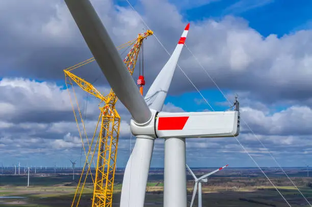 Wind turbine during installation of the star with rotor blades Aerial photograph and close-up view