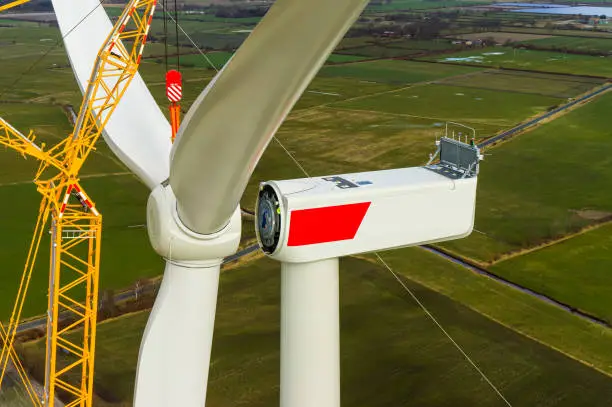 Wind turbine during installation of the star with rotor blades Aerial photograph and close-up view