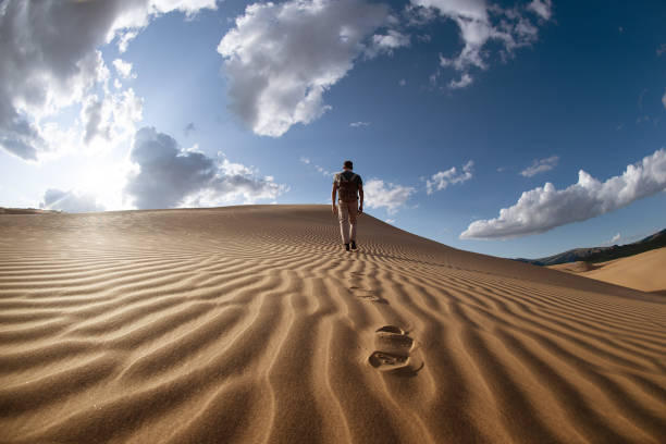 외로운 남자는 사막 모래 언덕에서 산책 - desert landscape morocco sand dune 뉴스 사진 이미지