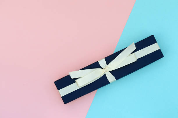 istock Beautiful gift box on a pink and blue background. Flat lay top view copy space 1174057501