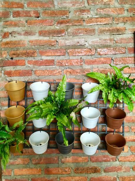 istock Cute flowerpot, ideas garden decoration on brick wall 1174058174