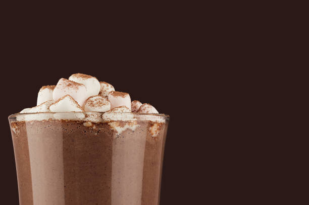 autumn warm drink - hot cocoa with marshmallows, cocoa powder closeup, details, top section on dark brown background, copy space. - hot chocolate hot drink high section close up imagens e fotografias de stock