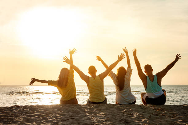 istock Happy friends seats beach having fun 1174059763