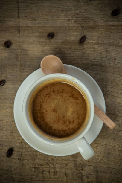 istock Coffee cup with wooden spoon and coffee beans 1174061149