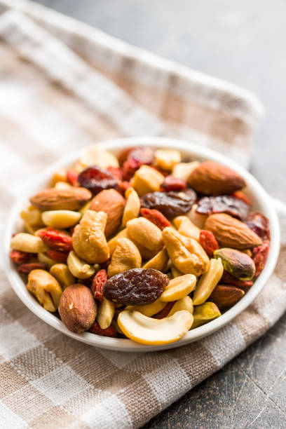 istock Mix of various nuts and raisins 1174061693