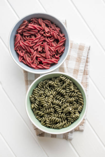 istock Uncooked colorful pasta with beetroot and spinach flavor 1174062053