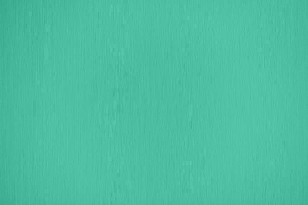 mint colored low contrast paper textured background Trendy mint colored low contrast paper textured background for your design or product. Color trend concept. mint green stock pictures, royalty-free photos & images
