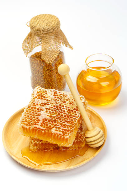 istock Honeycomb with jar and honey dipper isolated on white background 1174067283