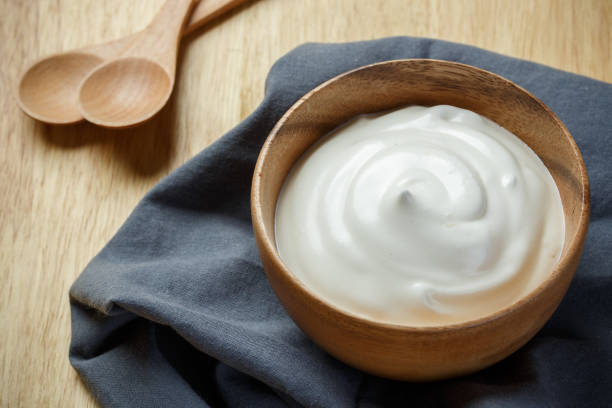 istock Greek yogurt on wooden background 1174068608