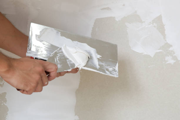 istock Process of plastering wall with putty-knife. Fixing wall surface and preparation for painting, home renovation concept 1174070649