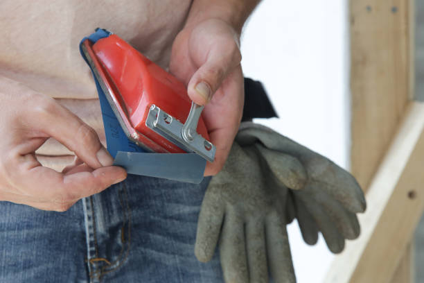 istock Man changing sandpaper on a sanding block, close up. Preparation before painting. Renovation house concept. 1174070698